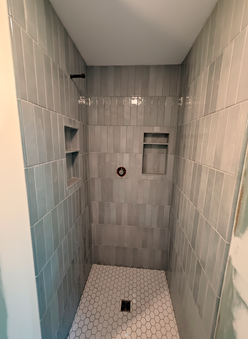 Professional tile installation in Richmond bathroom with decorative wall tiles and modern finish by Break & Build Interiors
